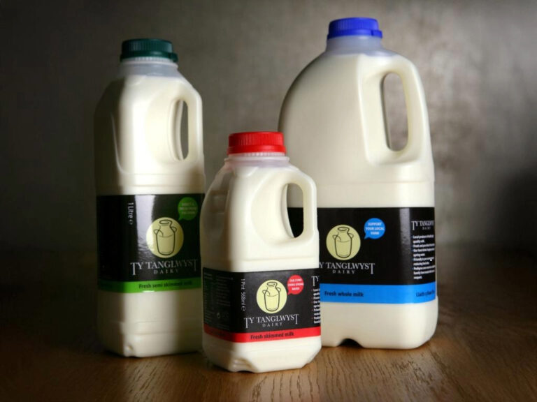 A trio of Ty Tanglwyst branded plastic milk bottles