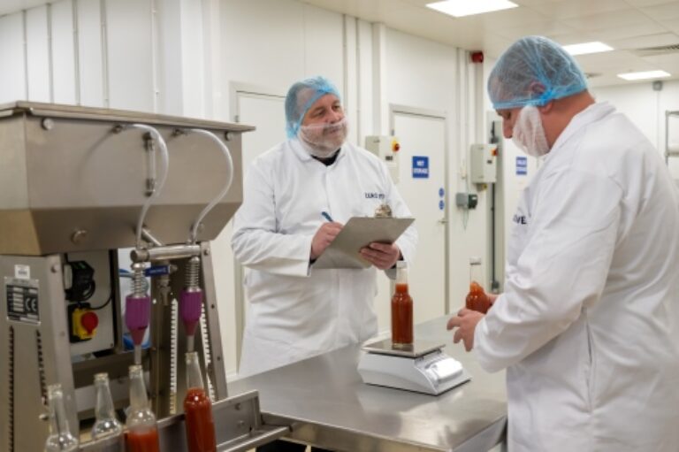 ZERO2FIVE Waste reduction staff checking weight of a food product