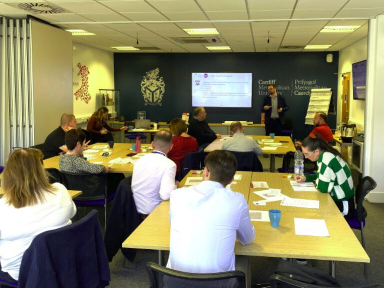 People attending food fraud workshop around table