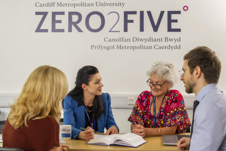 People discussing business around the ZERO2FIVE table