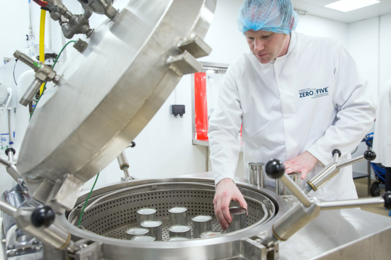 Food technologist using canning equipment