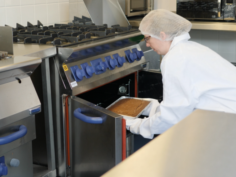 Food technologist using oven