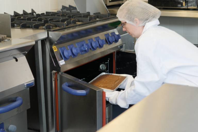 Food technologist using oven