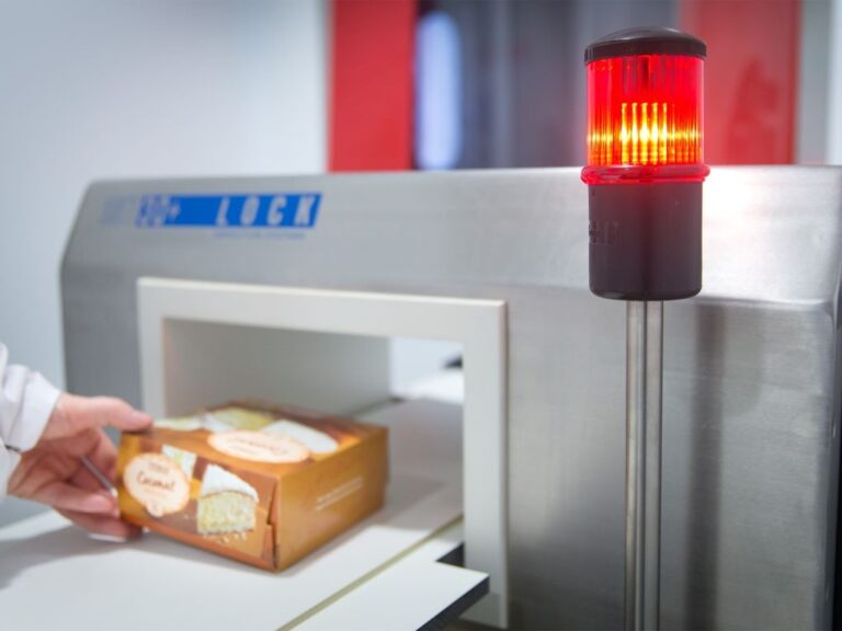 Cake in a box going through a metal detector