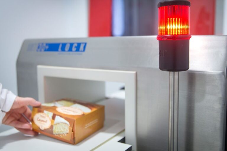 Cake in a box going through a metal detector