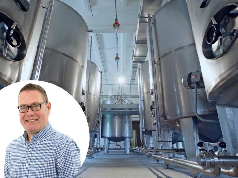 Simon Burns superimposed over a factory setting