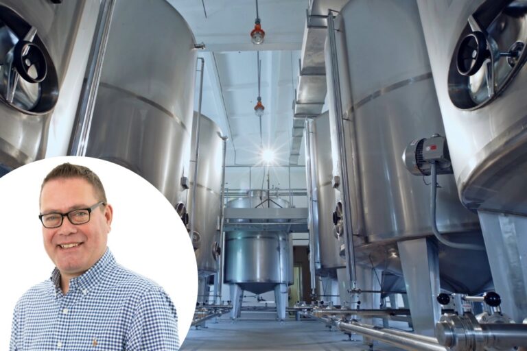 Simon Burns superimposed over a factory setting