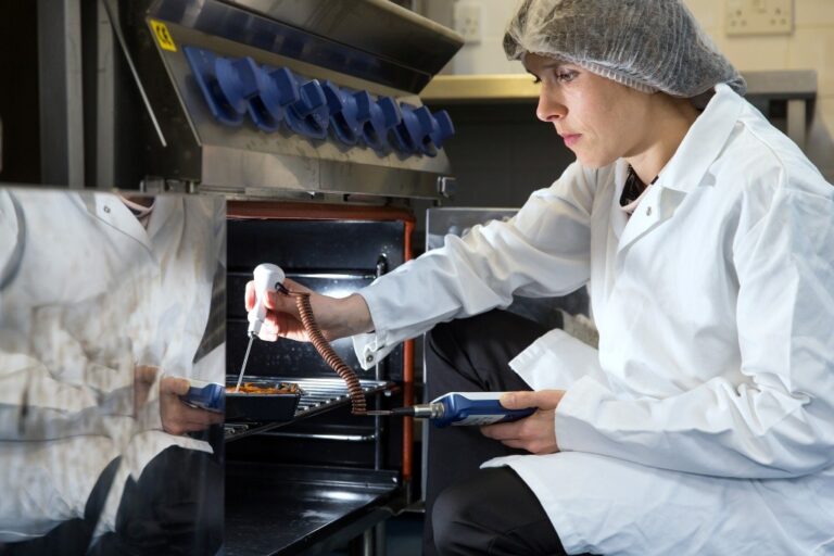 Food technologist inserting temperature probe into a ready meal